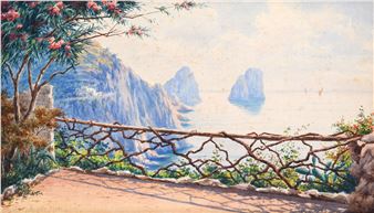 A sun-drenched coastal view framed by a rustic stone wall and flowering tree.