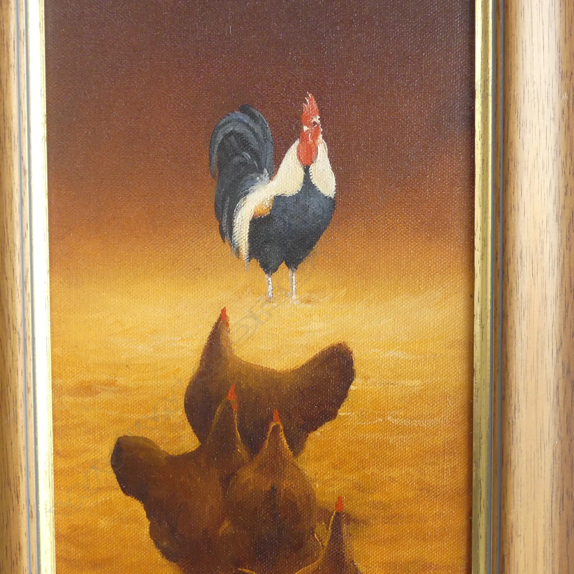 A framed painting of a rooster standing over three hens in a warm, earthy landscape.