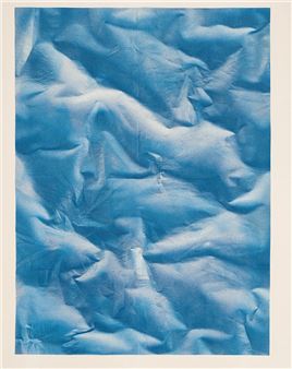 A textured abstract composition of crumpled blue fabric.