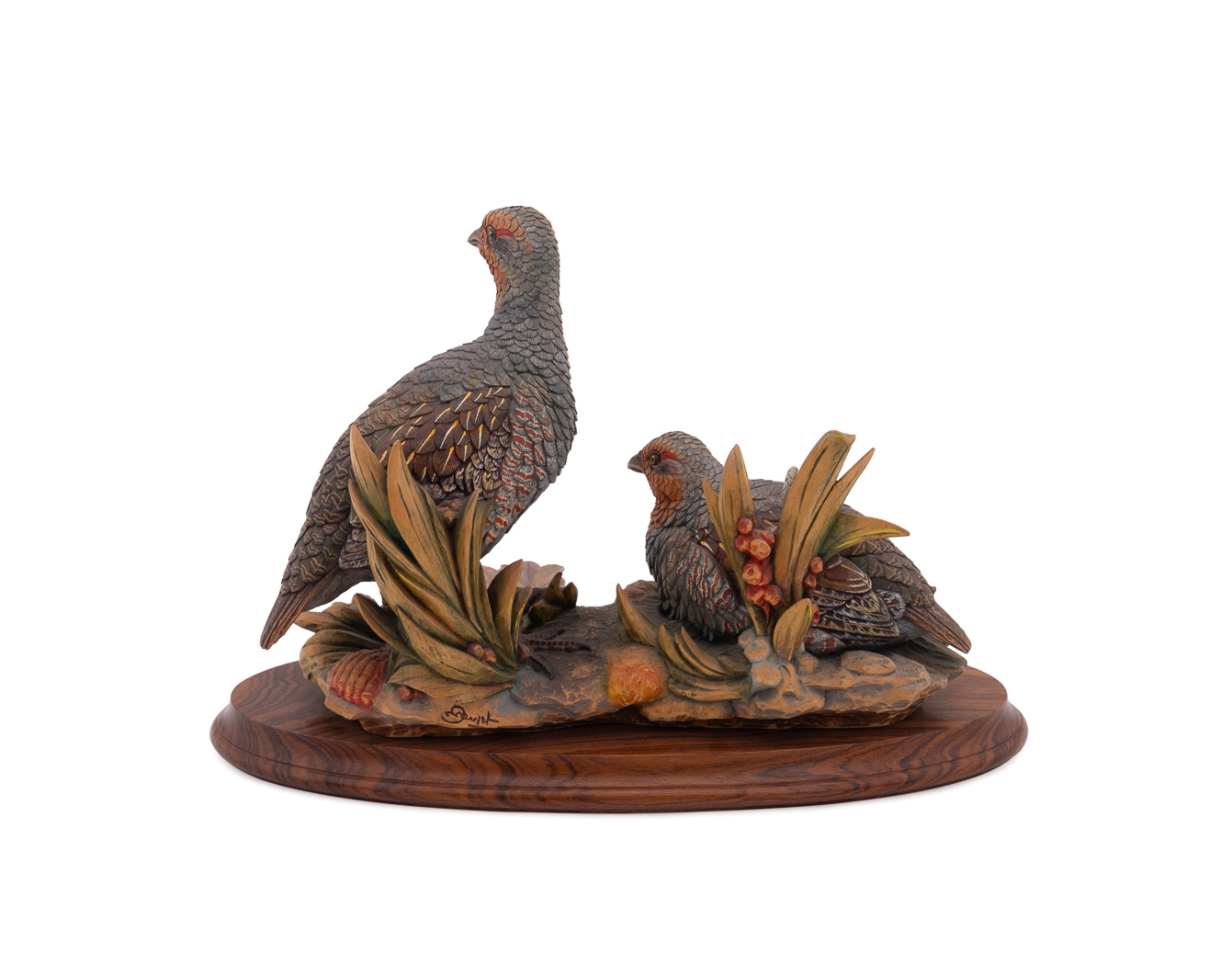 A set of four sculpted birds displayed on individual wooden bases.