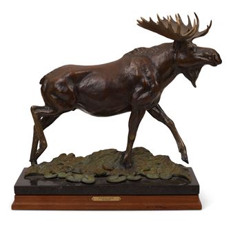 A bronze sculpture of a moose in motion, captured mid-stride on a textured base.