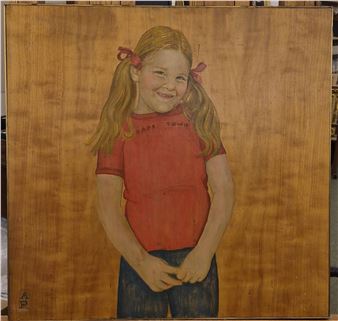 A portrait of a smiling girl in a red shirt against a wooden background.