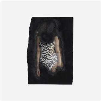 A mysterious figure in a patterned swimsuit stands against a dark, smoky backdrop.