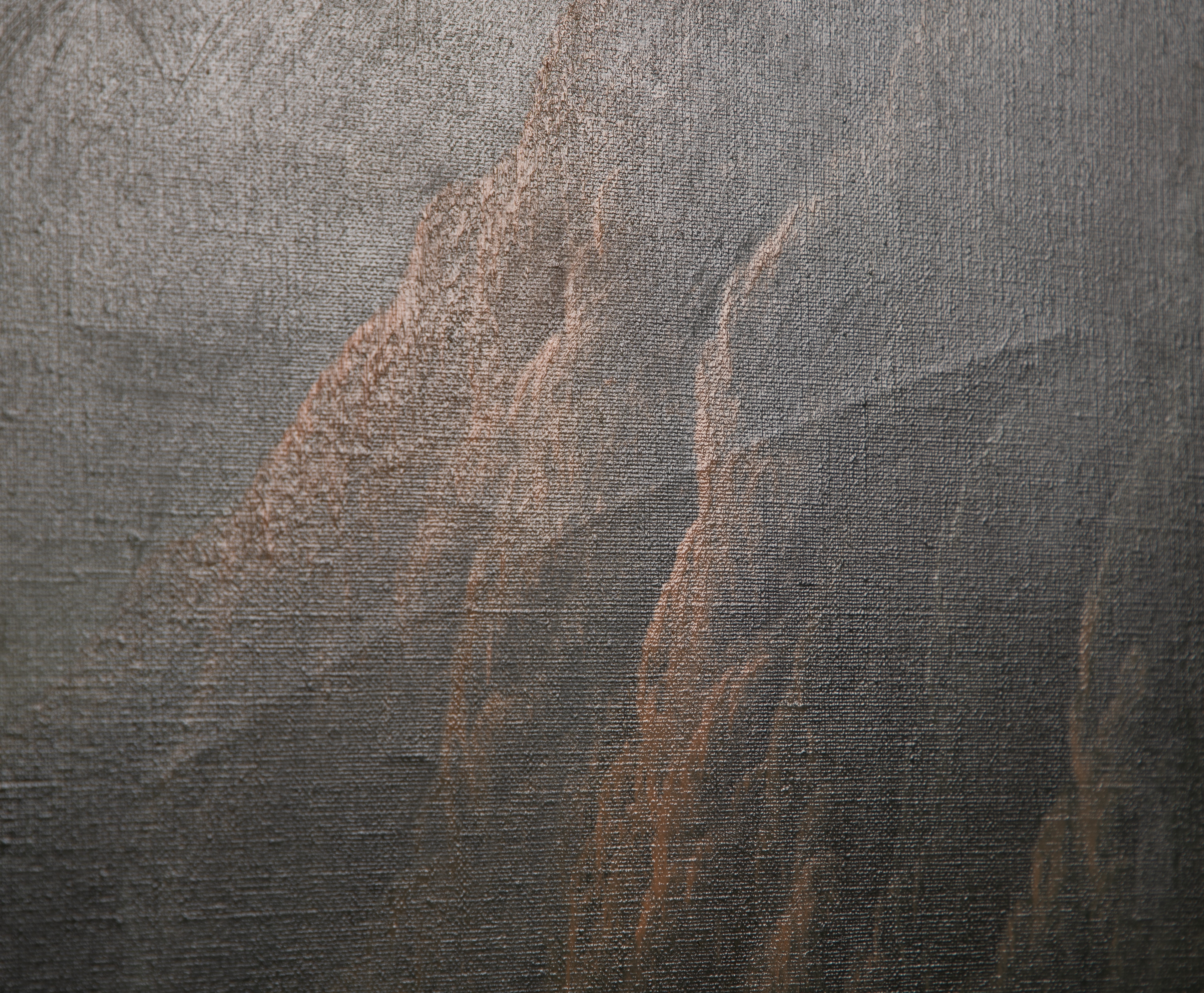 A romanticized mountain landscape featuring a lone figure in a vast, snow-dusted valley.
