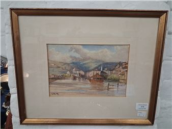 A framed watercolor painting of a riverside town with boats and hills.