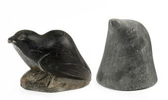 A pair of carved stone bird figures, one facing left and the other showing its back.