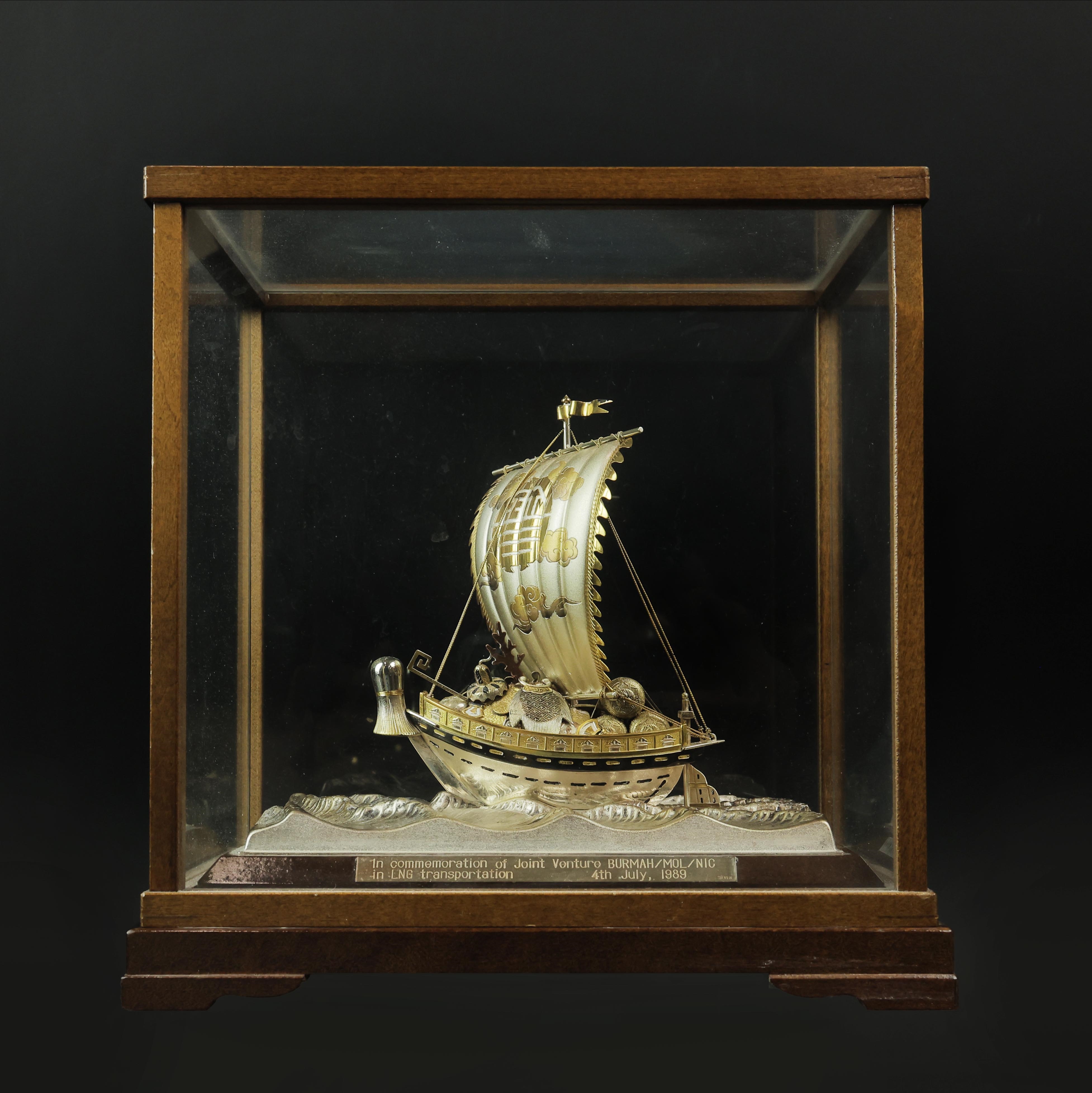 a-cased-silver-sailing-boat-