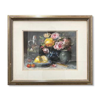A framed still life painting featuring a vibrant bouquet of flowers, lemons, and a glass pitcher on a table.