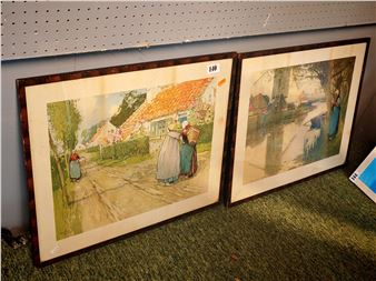 A pair of framed watercolor prints depicting rural village life.