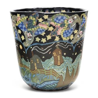 A whimsical ceramic cup featuring a night sky scene with floating figures and houses.