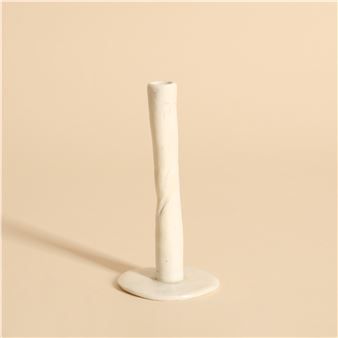 A minimalist ceramic candlestick with a twisted stem and flat base.