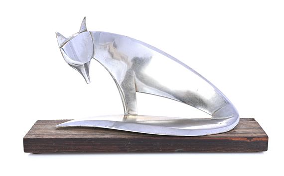 A sleek, metallic fox sculpture posed in a crouching stance on a dark wooden base.