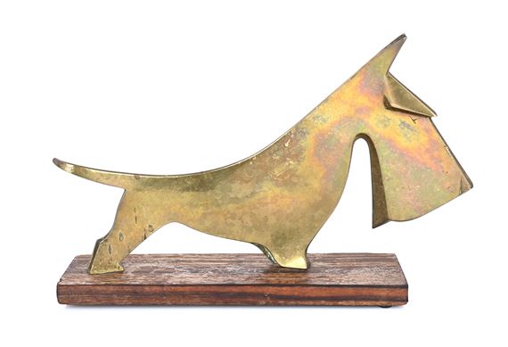 A stylized brass sculpture of a dog in motion mounted on a wooden base.