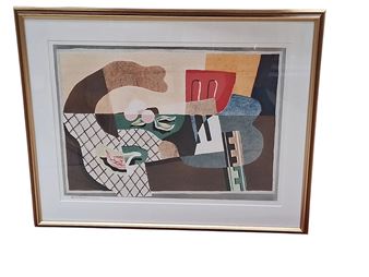 A framed collage-style portrait featuring a fragmented face in earthy tones and geometric patterns.