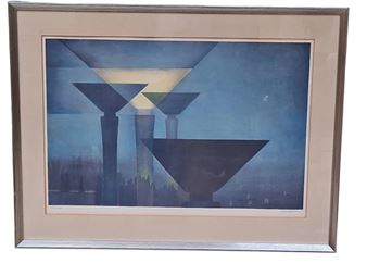 A framed abstract print featuring geometric shapes and a city skyline silhouette.