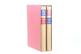 A set of two hardcover books in a pink slipcase.