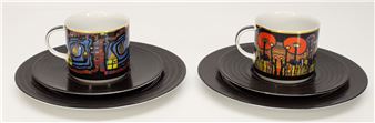 A pair of ceramic cups and saucers featuring vibrant, stylized cityscape designs.