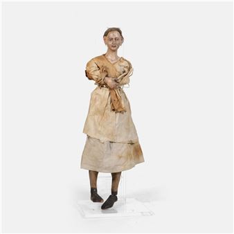 A life-sized figure in a stained dress stands solemnly against a stark white background.