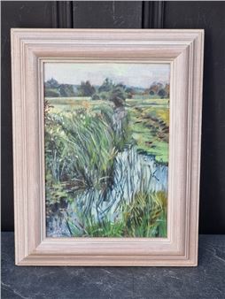 A framed landscape painting of a rural stream scene with tall grasses and distant trees.