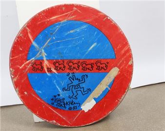 Dessin au marqueur noir sur panneau de signalisation portant une signature en bas en son centre et une date 85. Picture