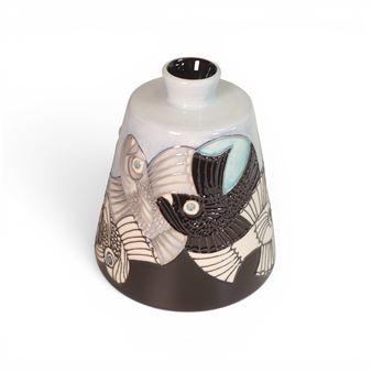 A ceramic vase featuring stylized fish designs in black, white, and light blue against a gradient background.