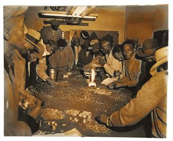 Checkers Club members, including J. Cephus Ford with scale, (Brother) Howell, (Chinny) Moore, Oliver Gray, John Henry, Joe Smith, (Hot Rod), (Braddock Red), (Pretty Eddie) or Birmingham, (Geech), (Red), (Arkansas Fats), (Slim) Owens, A. Brown, (Blue), (Tilly), (Can’t Spare It) Marvin and (North Side Will) counting coins for NAACP and crippled children benefit, taken December 1957, printed later, silver gelatin photograph, 8 x 10 inches, unframed. Picture
