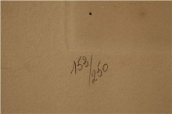 A close-up of a textured brown surface with handwritten numbers.