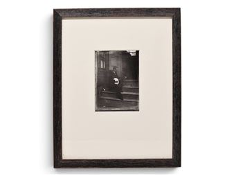 A framed black-and-white photograph of a figure descending steps.
