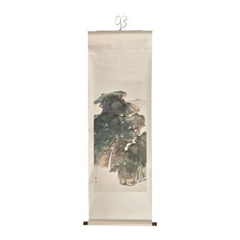A vertical ink painting of a misty mountain landscape on a scroll.
