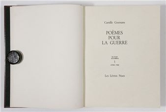 An open book with a dark textured seal on the left page.