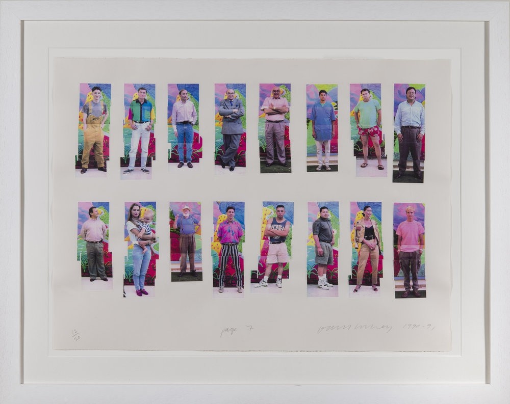 A group of people standing in front of a white frame.