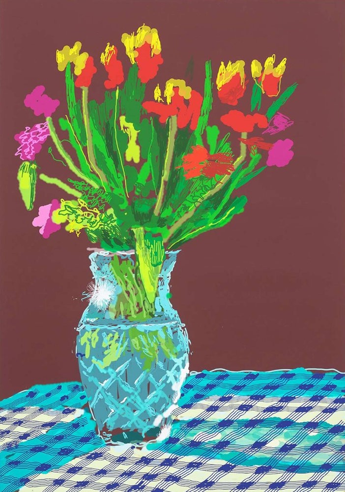 A vase of flowers sitting on a table with a blue and white checkered table cloth.