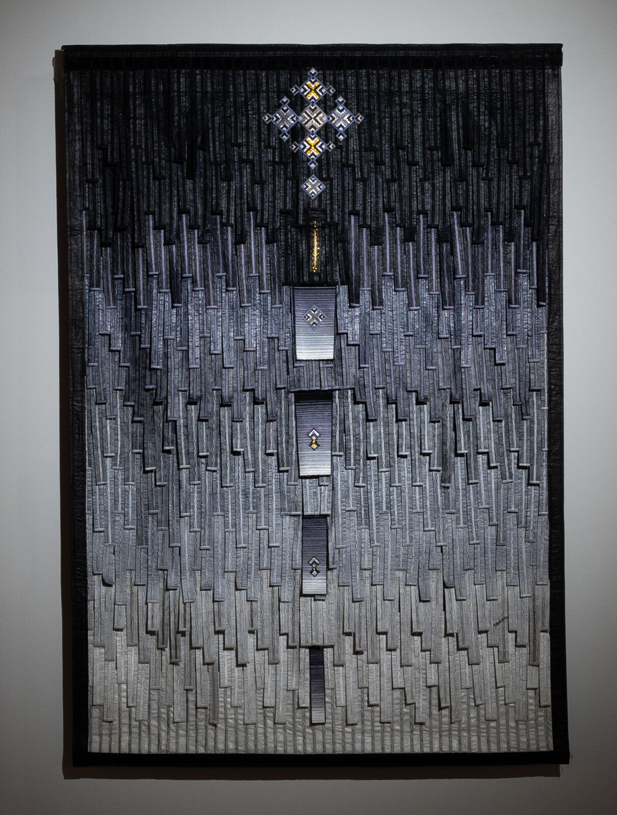 A picture hanging on a wall in a dark room.