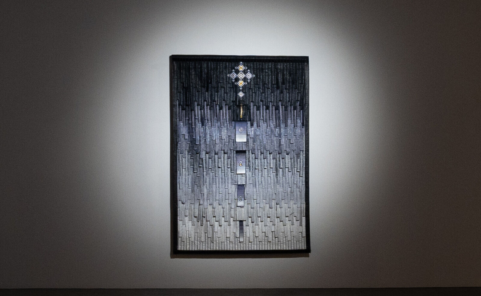 A picture hanging on a wall in a dark room.