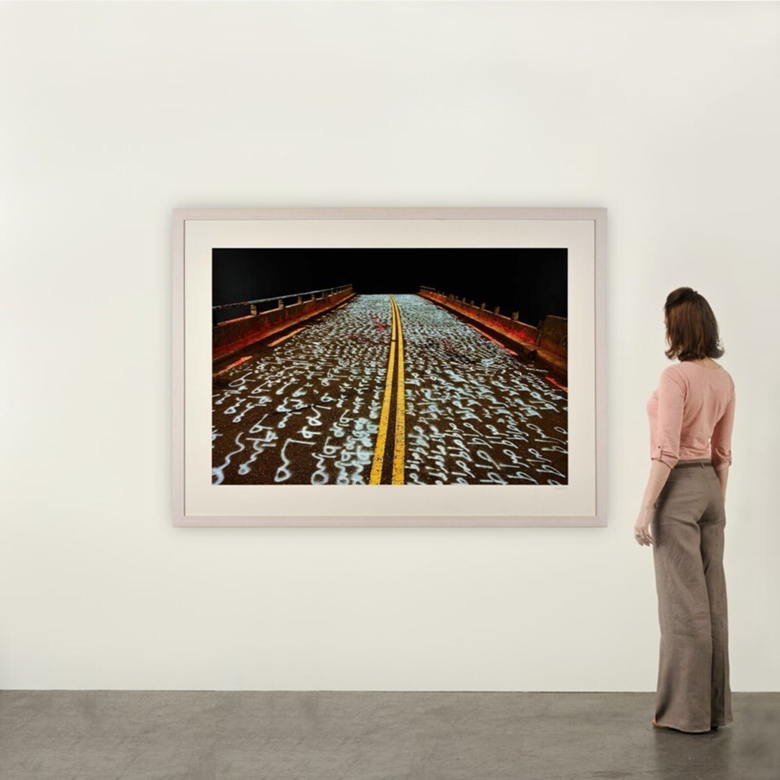 A picture of a road with writing on it.