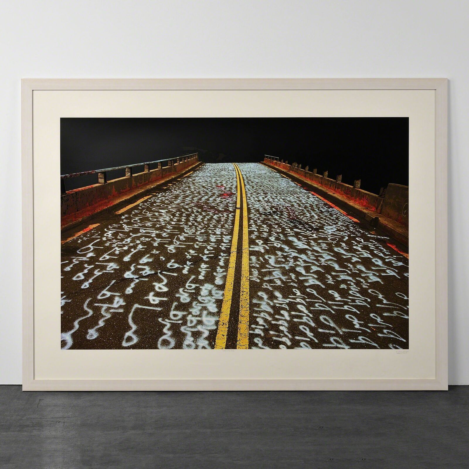 A picture of a road with writing on it.