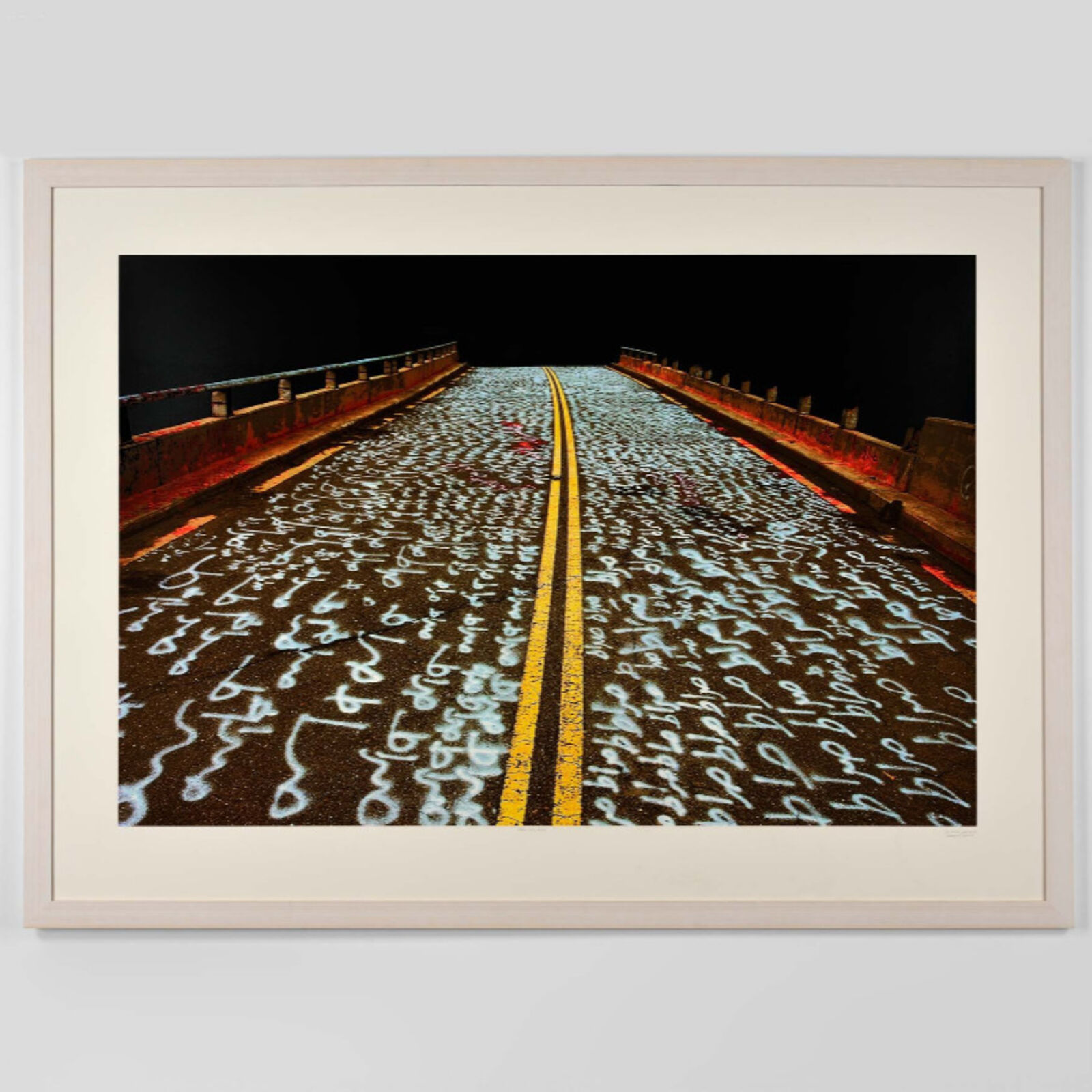 A picture of a road with writing on it.