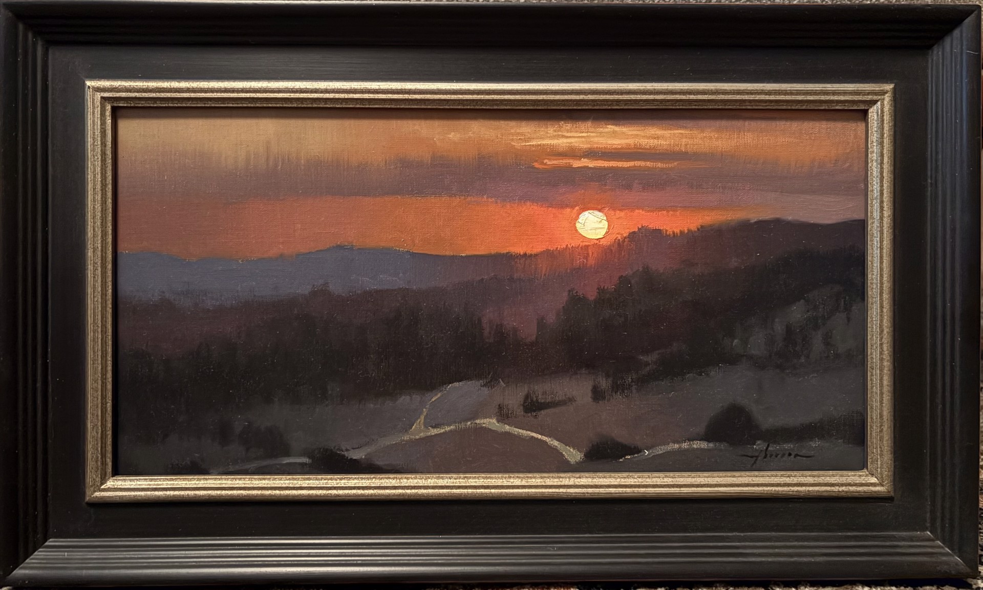 A landscape painting of a sunset over rolling hills with a winding path.