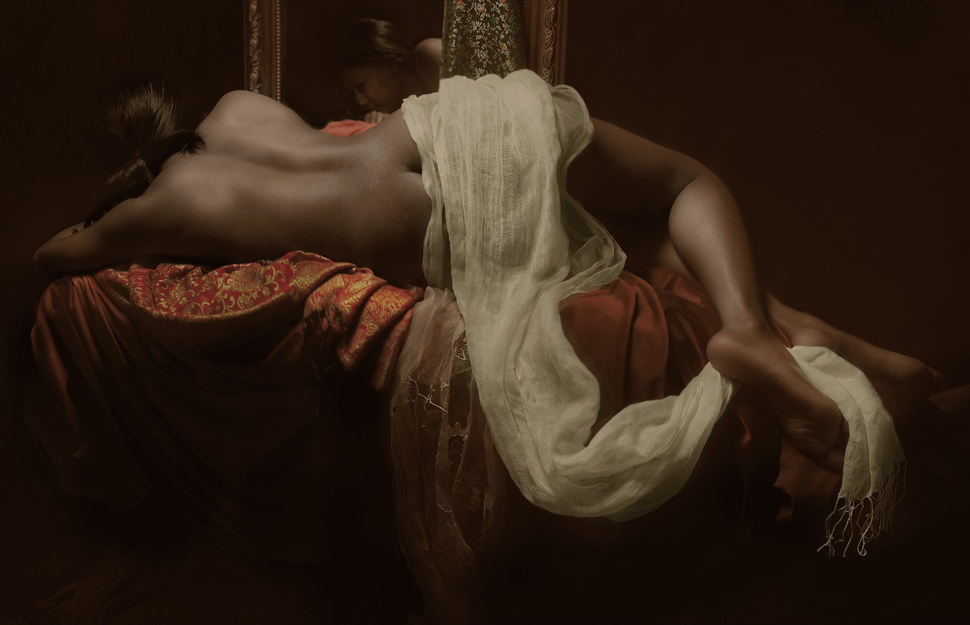 A dramatic, classical-style painting of a reclining figure in rich fabrics.