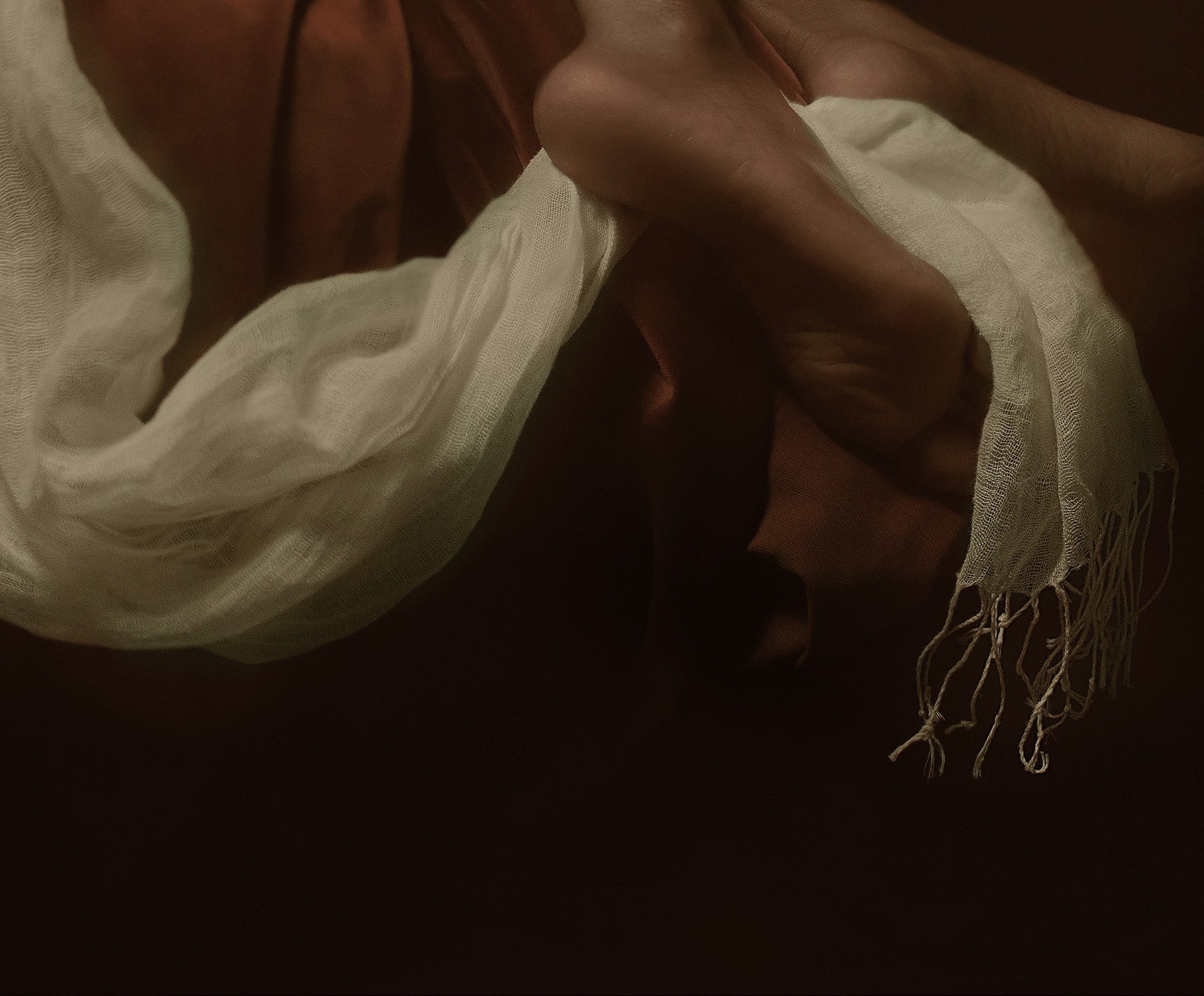 A dramatic, classical-style painting of a reclining figure in rich fabrics.
