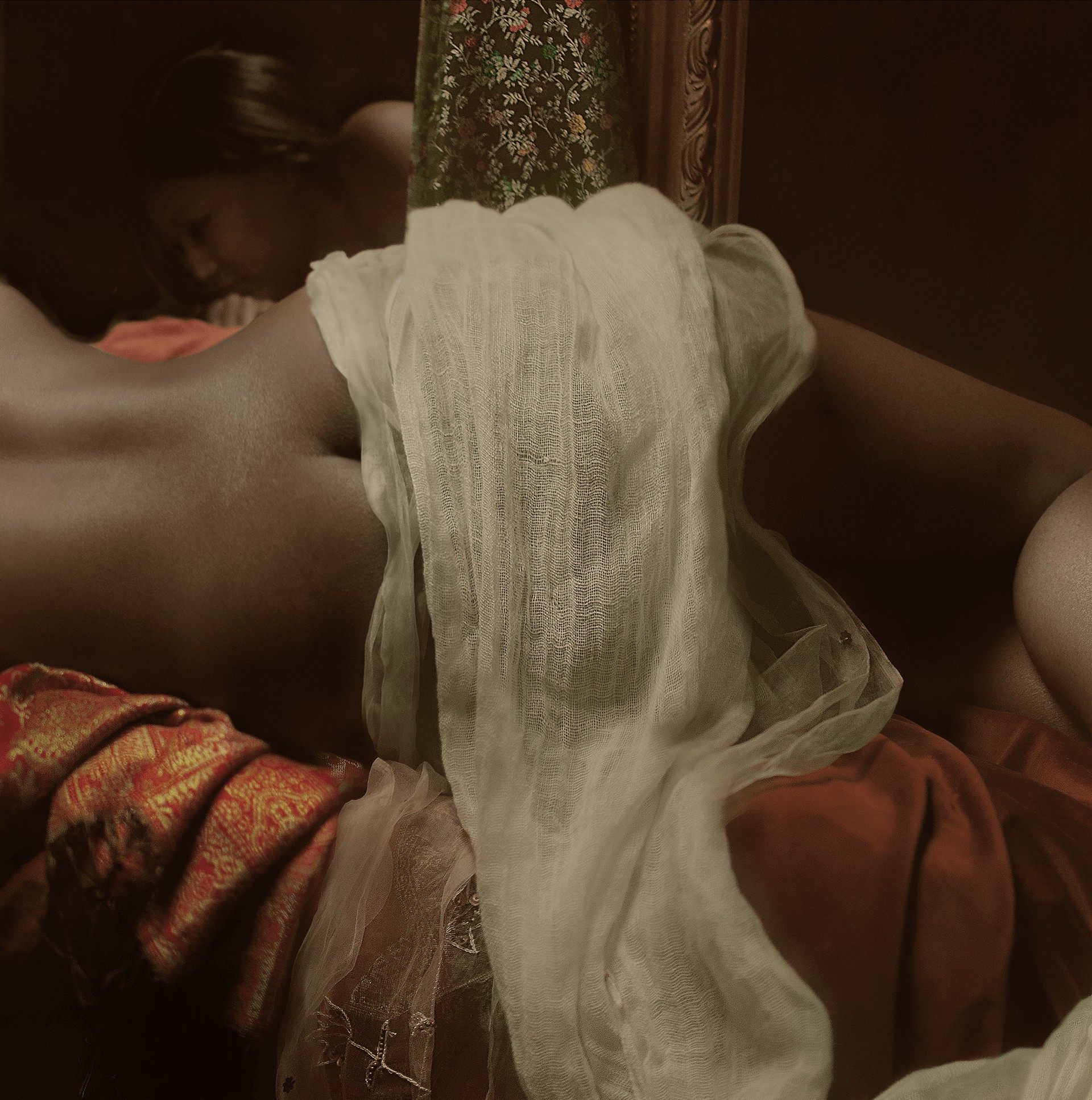 A dramatic, classical-style painting of a reclining figure in rich fabrics.
