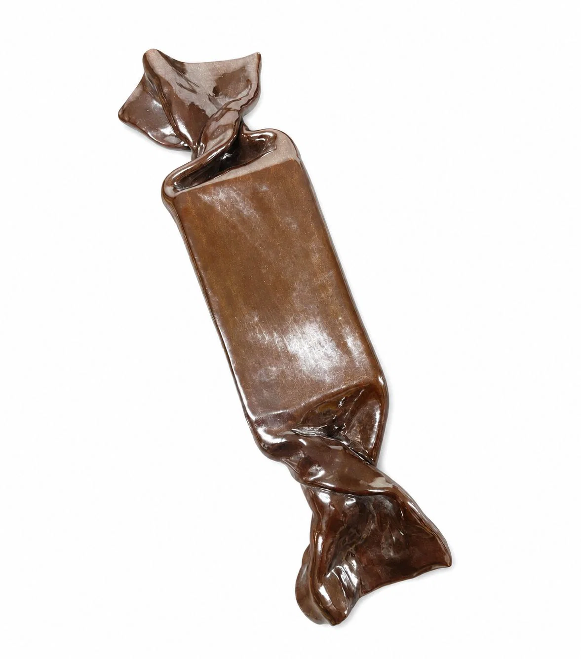 A glossy, chocolate-colored ceramic sculpture shaped like a wrapped candy.