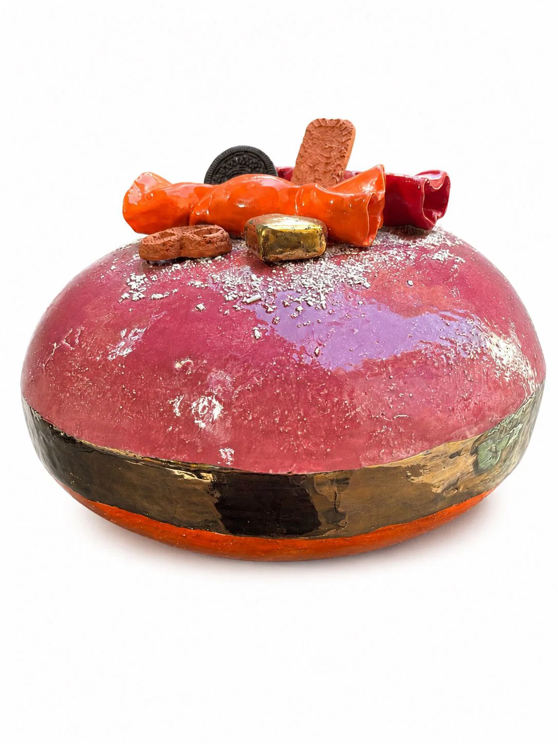 A glossy, pinkish-red ceramic vessel with a gold rim and an assortment of miniature food items resting on top.