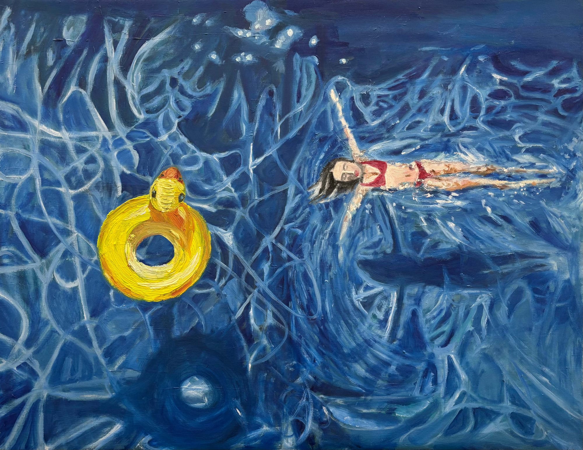 A figure floats in turbulent blue water next to a large yellow rubber duck ring.
