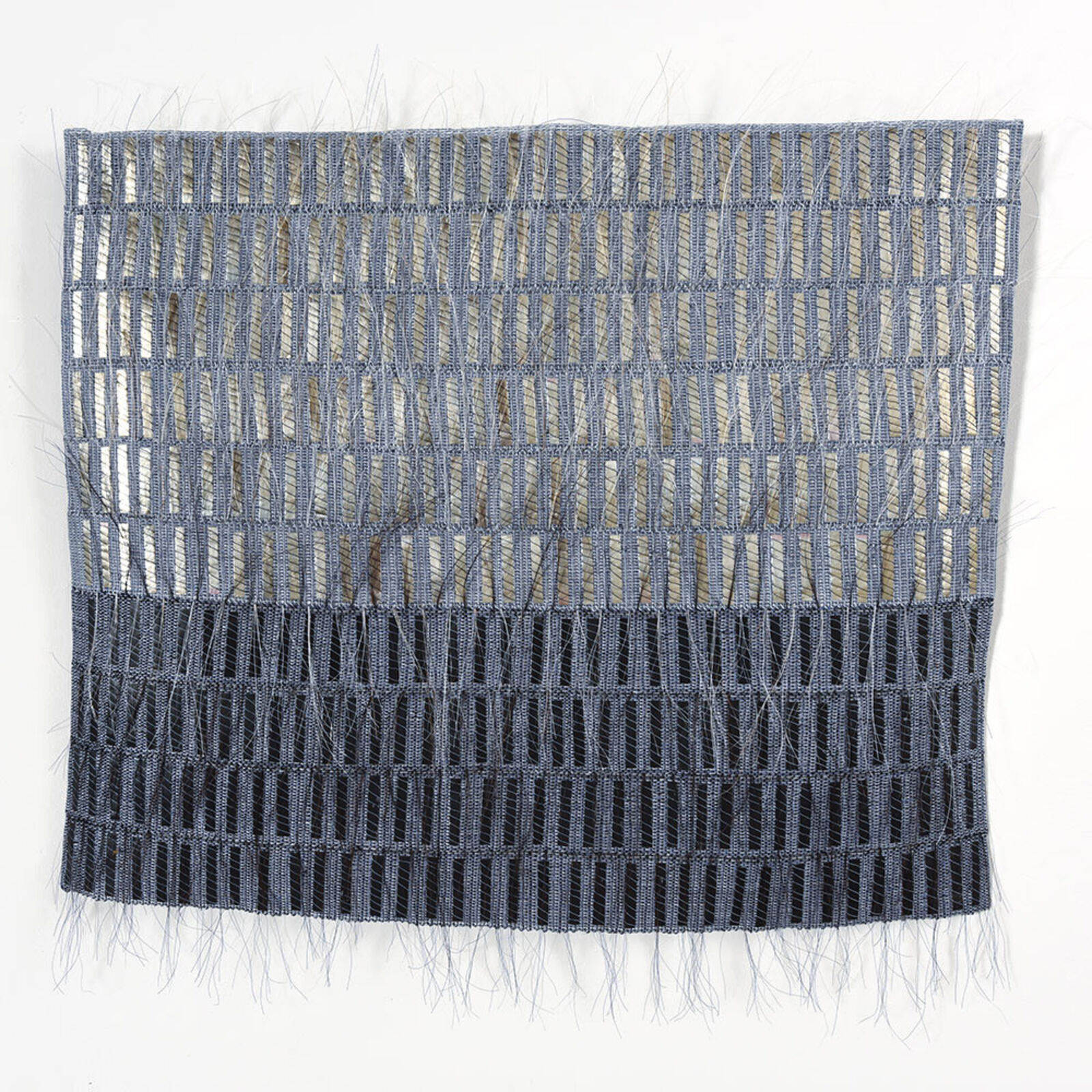 A piece of woven fabric on a white surface.