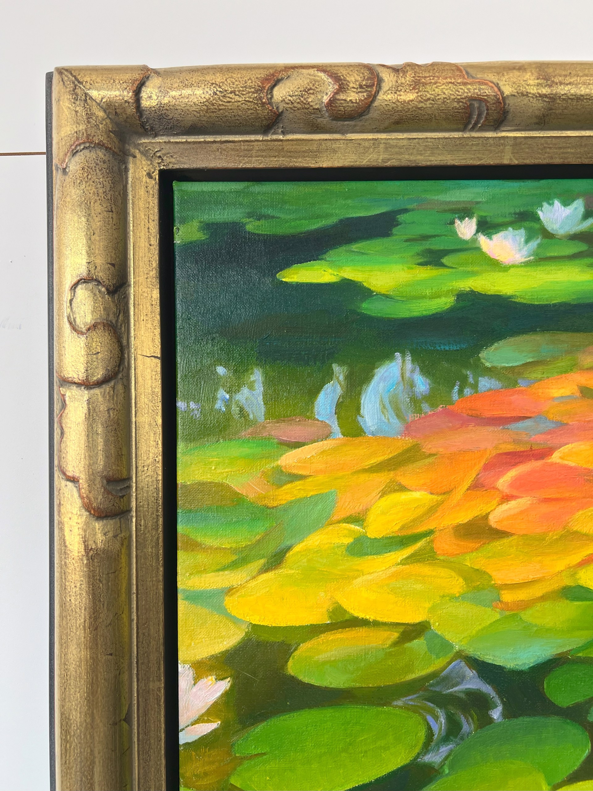 A painting of water lilies in a pond of water.