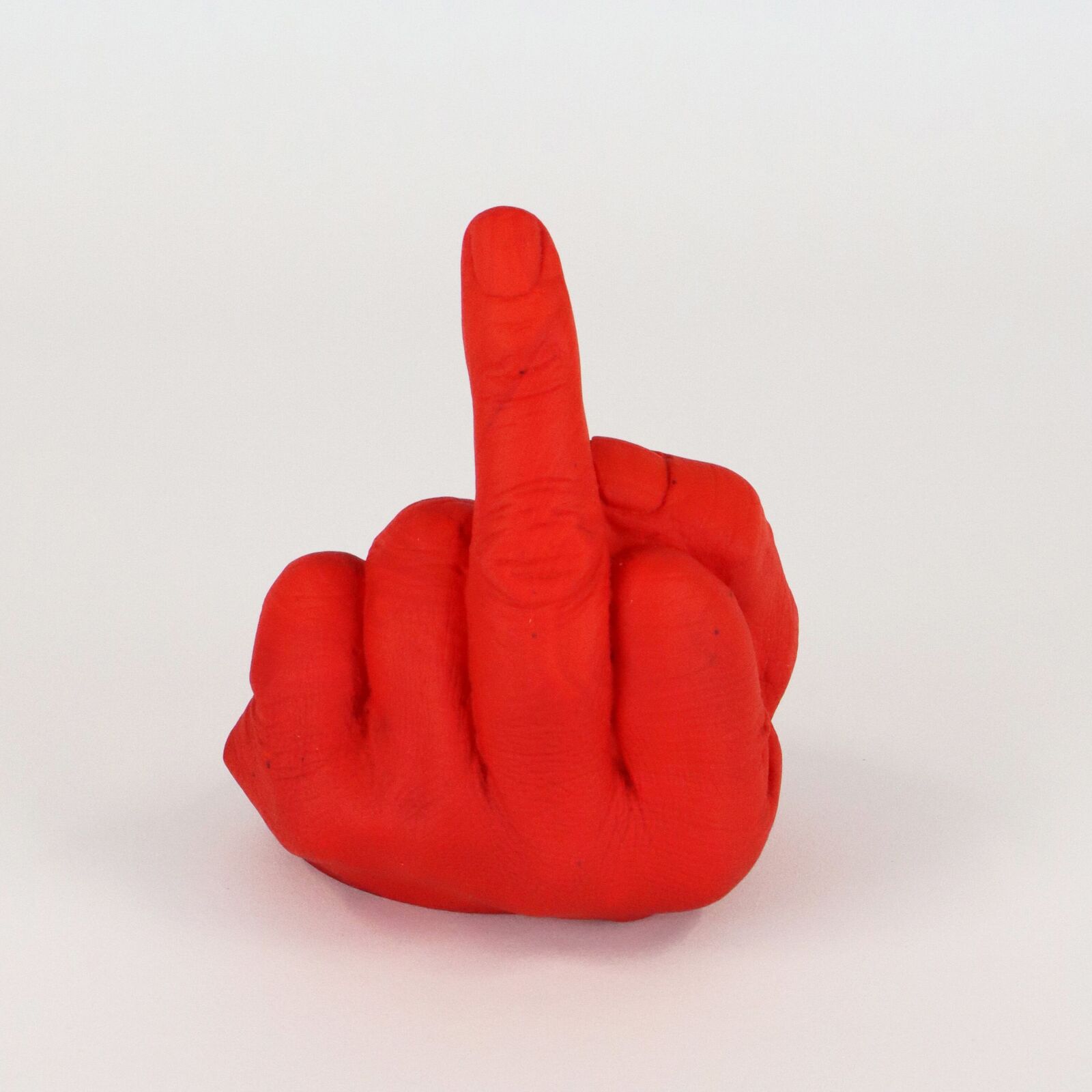 A row of six translucent, colorful hand sculptures in the middle finger gesture.