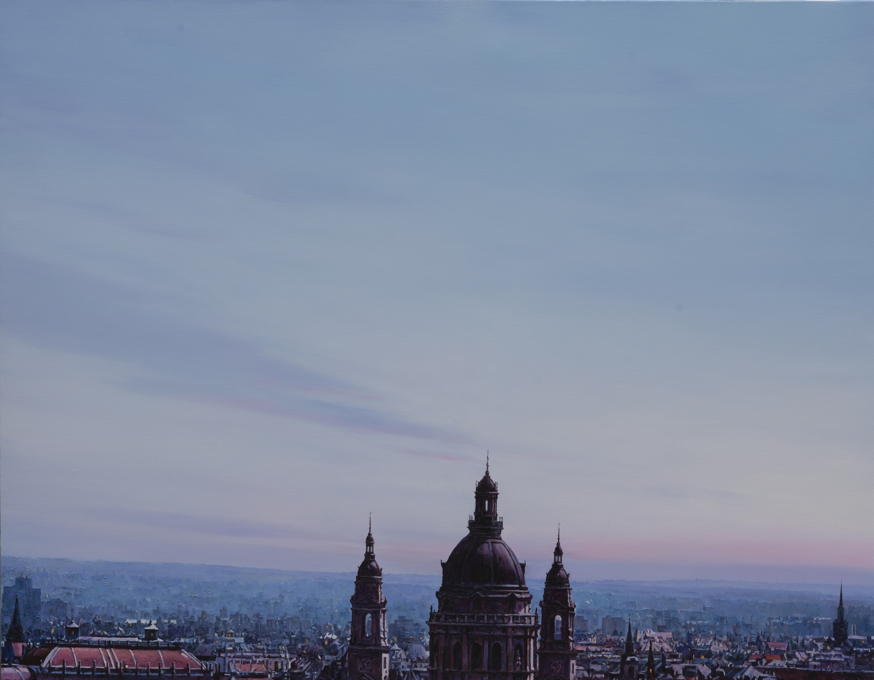 A view of a city with a clock tower in the middle of it.