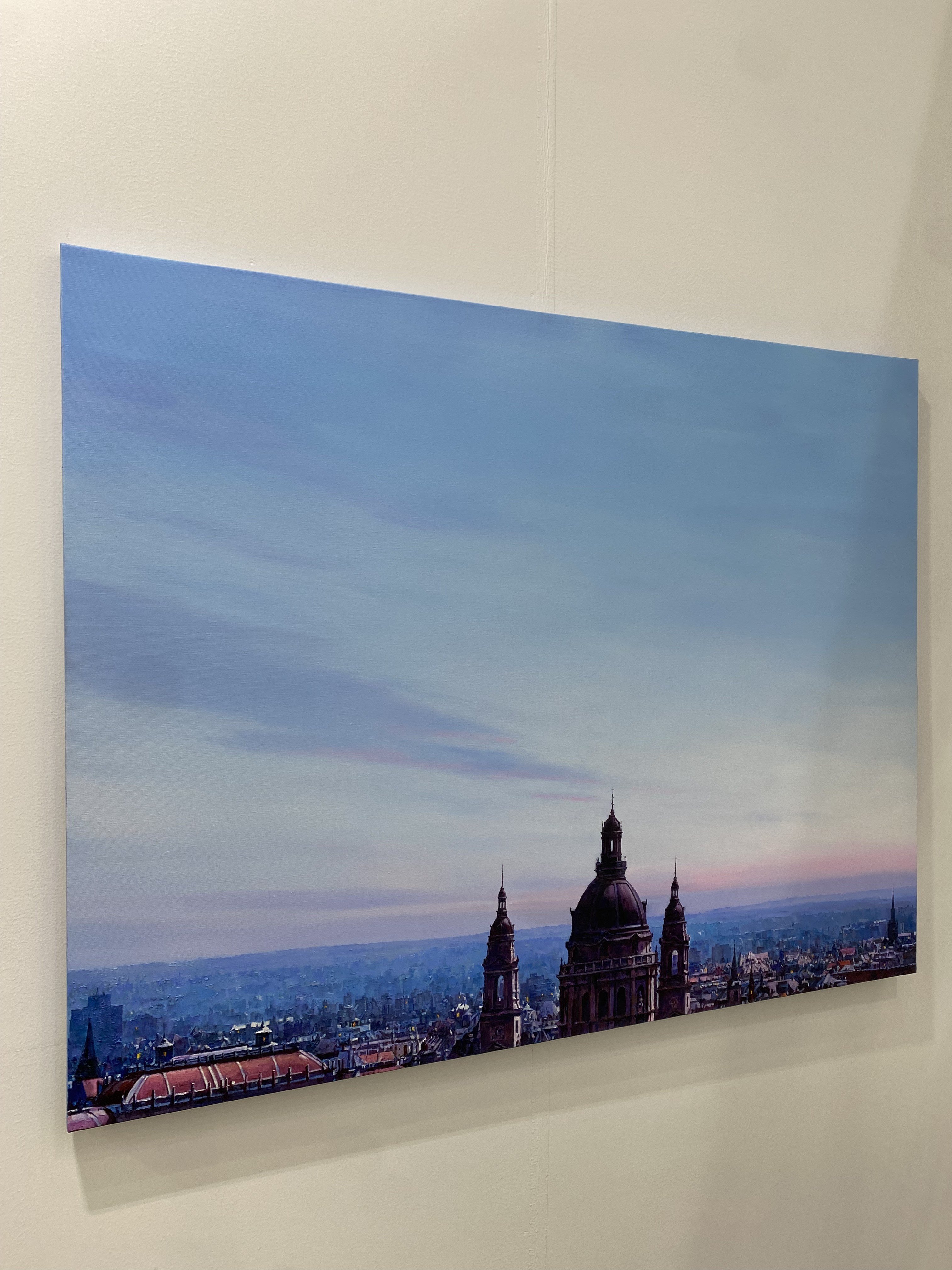 A view of a city with a clock tower in the middle of it.
