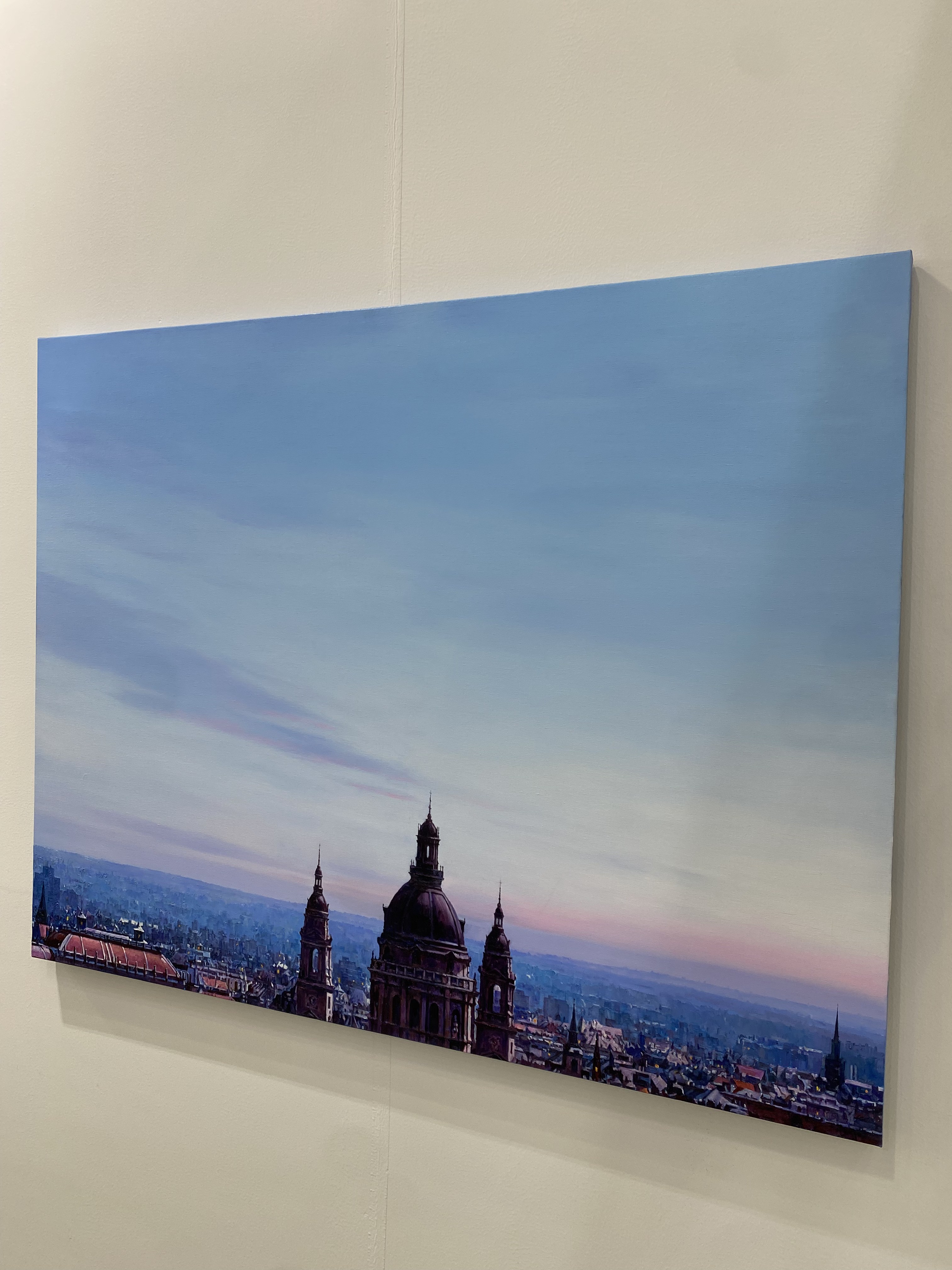 A view of a city with a clock tower in the middle of it.